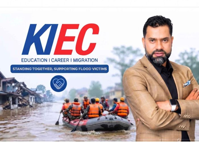Promotional image for NEC disaster relief showing a man in a tan suit beside the NEC logo and flood-relief volunteers on a boat.